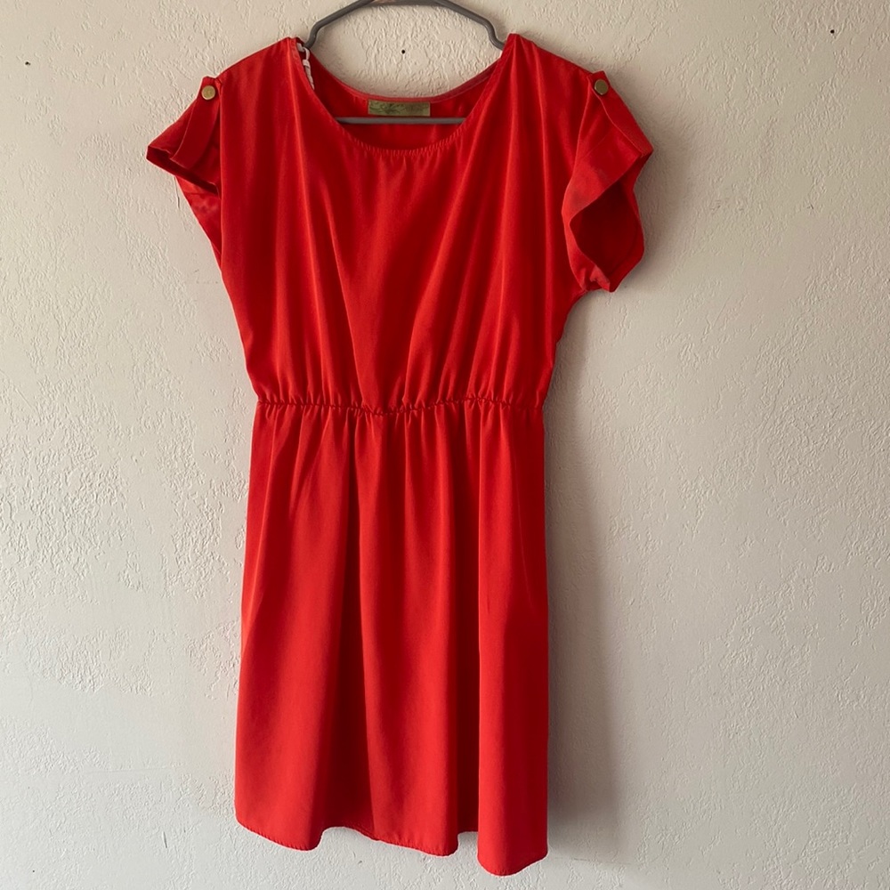 Orange dress with gold detail button on sleeve